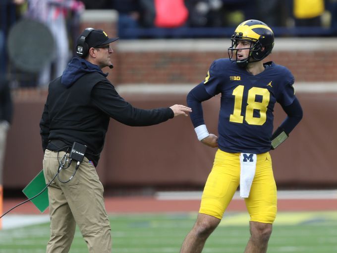 Michigan defensive back Ambry Thomas (1) tries to rip the ball